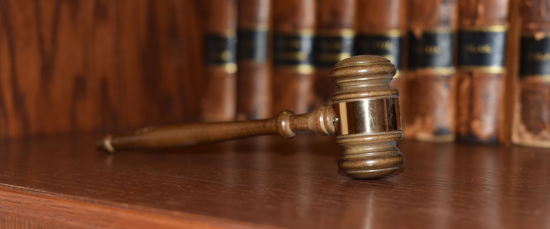 Wooden gavel on a bookshelf